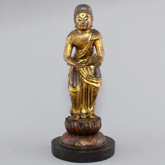 A Chinese gilt and laquered wood figure of a female deity, 18/19th C.