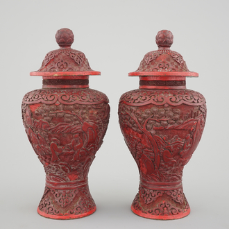 A pair of Chinese carved cinnabar lacquer vases and covers, 18/19th C