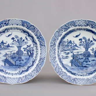 A pair of blue and white Chinese porcelain plates with a vase in a garden, Qianlong, 18th C.
