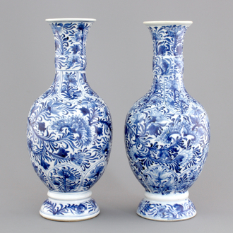 A pair of Chinese porcelain blue and white flower scroll vases, Kangxi, ca. 1700