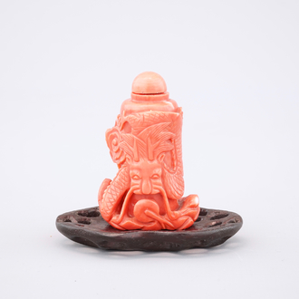 A Chinese carved red coral dragon snuff bottle on stand, 19th C.