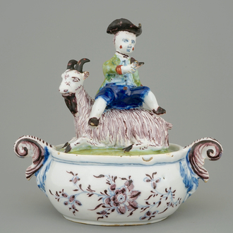 A Dutch Delft polychrome butter tub with a buckrider, 18th C.