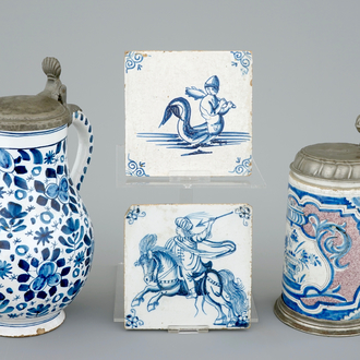Two pewter-mounted Delft jugs and two blue and white tiles, 17/18th C.