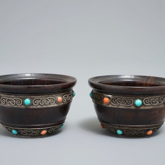 A pair of Tibetan wooden cups with turquoise- and coral-inlaid silver mounts, 19th C.