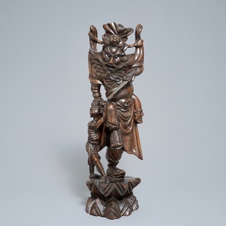 A tall Chinese silver-inlaid wooden figure of Zhong Kui, 19th C.