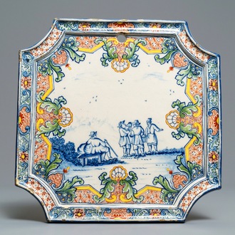 A Dutch Delft polychrome mixed technique plaque with figures in a landscape, 18th C.