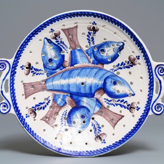 A large blue and manganese Frisian Delft fish strainer, Tichelaar, Makkum, 19th C.