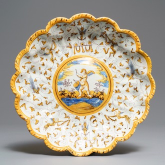 A lobed Dutch maiolica dish on foot with a putto surrounded by grotesques, Willem Jansz Verstraeten, Haarlem, ca. 1650