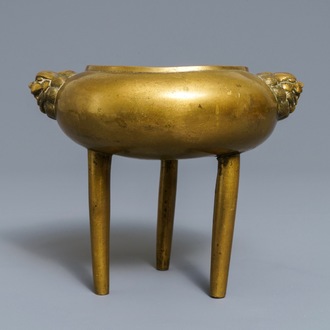 A Chinese bronze tripod censer with lion head handles, 19/20th C.