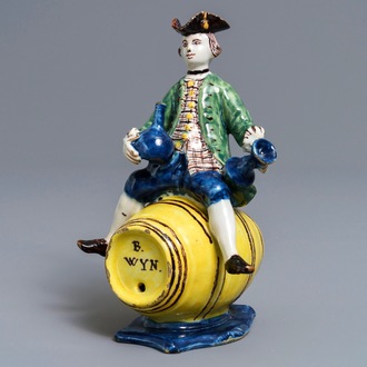 A polychrome Dutch Delft figure of a man on a barrel, 18th C.