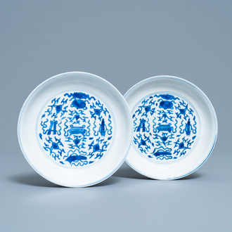A pair of Chinese blue and white plates with taoist symbols, Kangxi mark and of the period