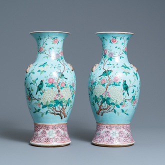 A pair of Chinese famille rose turquoise-ground vases with butterfly handles, 19th C.