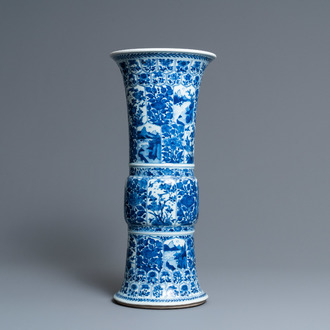 Een Chinese blauw-witte 'gu' vaas met florale en landschapspanelen, Kangxi