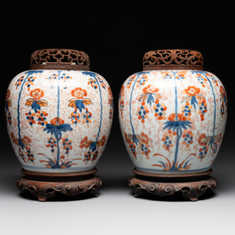 A pair of Chinese Imari-style 'grapevine' jars with wooden covers and stands, Kangxi
