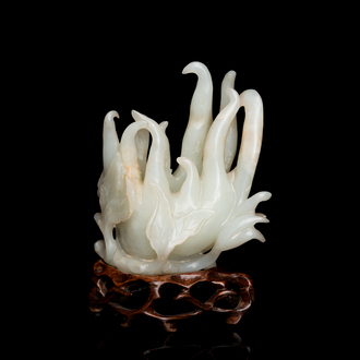 A fine Chinese white jade Buddha's hand on wooden stand, Qing