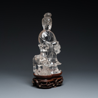 A Chinese rock crystal sculpture of Lan Caihe on wooden stand, 19th C.