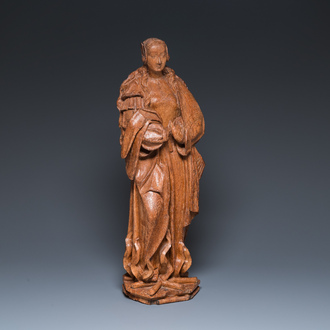 A Flemish late gothic carved oak sculpture of Saint Thecla on a pyre, Brabant region, first half 16th C.
