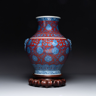 A Chinese blue, white and iron-red 'bajixiang' 'hu' vase on wooden stand, Qianlong mark, 19th C.