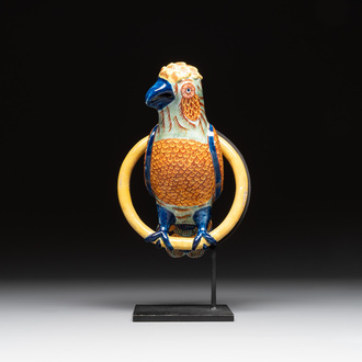 A polychrome Dutch Delft parrot on a later metal stand, 18/19th C.