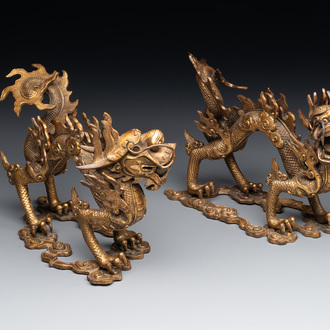A pair of Chinese gilt bronze dragons among flames and clouds, 19/20th C.