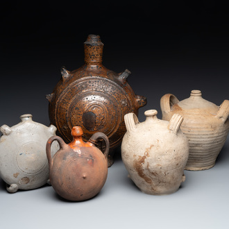 Five stoneware jugs or pilgrim flasks, including a Raeren example with armorial design, 16/17th C. and later