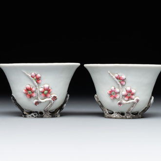 A pair of Chinese Dehua blanc de Chine relief-decorated famille rose 'prunus' cups, 19th C.
