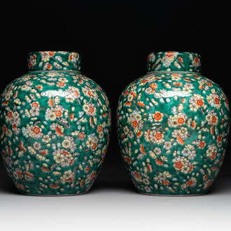A pair of Chinese famille verte green-ground 'prunus' jars and covers, 19th C.