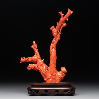 A Chinese carved red coral group with goddesses on wooden stand, 19/20th C.