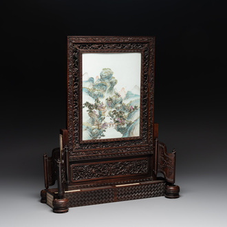 A large Chinese carved wooden table screen with a fine famille rose 'landscape' plaque, 19th C.