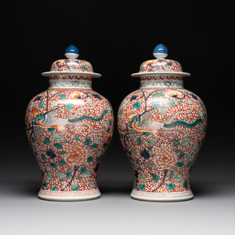 A pair of Chinese famille verte 'phoenix' vases and covers, 19th C.