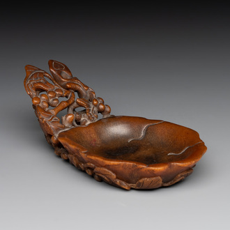 A rare Chinese carved rhinoceros horn 'libation cup' with grape design, 17/18th C.
