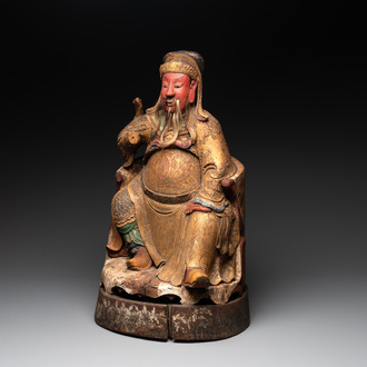 A large Chinese gilt- and polychromed wooden sculpture of a divinity, 19th C.