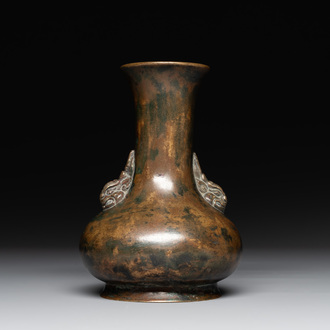 A small Chinese bronze bottle vase with lion-form handles, Qing, 17th C.