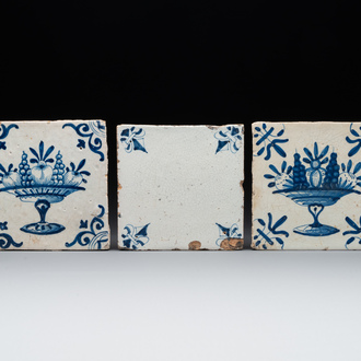 A rare 'empty' blue and white Dutch Delft tile and two 'fruit bowl' tiles, 17th C.