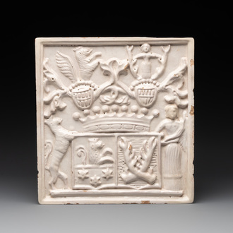 A rare white-glazed stove tile with an alliance coat of arms, Germany or Switzerland, 17th C.