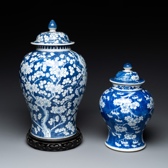 Two Chinese blue and white 'prunus on cracked ice' vases and covers, Kangxi mark, 19th C.