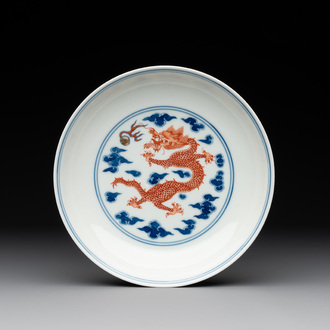 An imperial Chinese blue, white and iron-red 'dragon' plate, Qianlong mark and of the period