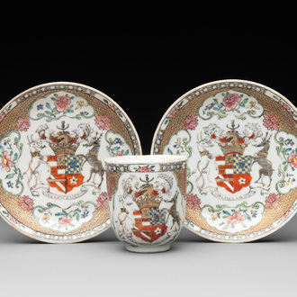 A fine Chinese famille rose armorial cup and two saucers, Yongzheng/Qianlong