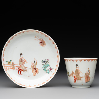 A Chinese famille rose cup and saucer with a lady playing flute, a boy and a phoenix, Qianlong