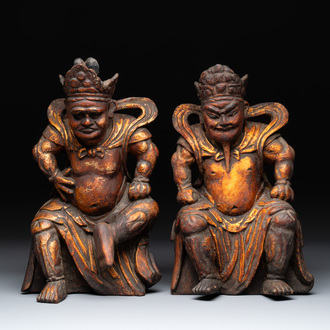 A pair of Chinese gilt-lacquered wooden sculptures of guardians, Qing