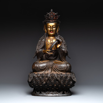 An impressive and large Chinese partially lacquered and gilt bronze Guanyin on a lotus throne, Ming