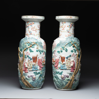 A pair of Chinese famille rose '18 luohan' vases with relief design, 19th C.