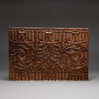 A Gothic carved oak front panel of a chest with arcades and rosettes, France, late 15th C.