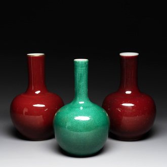 A Chinese apple-green-glazed and two copper-red-glazed bottle vases, Kangxi mark, 19/20th C.