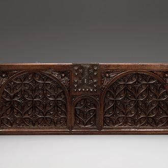 An ornately carved front panel of a late Gothic oak chest, presumably France, 15th C.