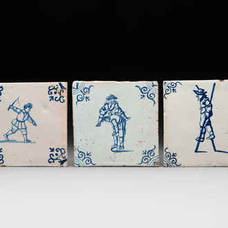 Three blue and white Dutch Delft tiles with children's games, 17th C.