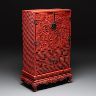 A Chinese cinnabar lacquer 'mountainous landscape' cabinet on a stand, 19th C.