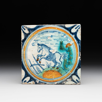 A polychrome Dutch Delft maiolica 'medallion' 'horse' tile, late 16th C.