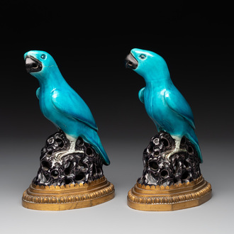 A pair of turquoise- and aubergine-glazed parrots with gilt bronze mounts, Kangxi