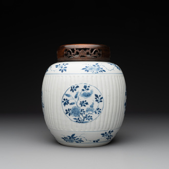 A Chinese blue and white jar with floral design and a wooden cover, Kangxi